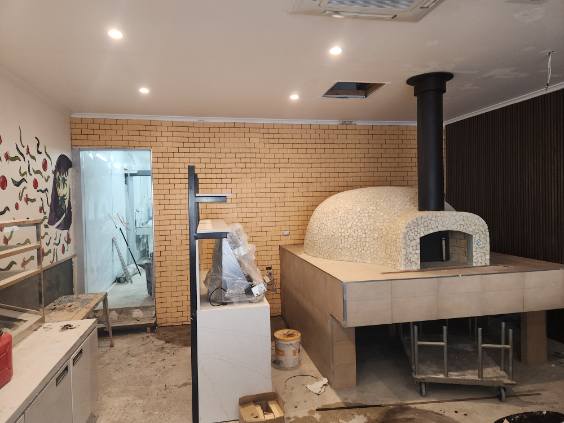 Small detail mosaic tiling on a wood-fired pizza oven
